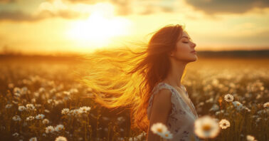 Woman walking through a field of daisies