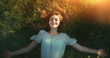 Joyful woman lying on the grass