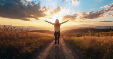 Woman standing on a dirt road