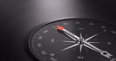 Black compass pointing north