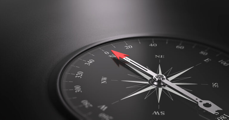 Black compass pointing north