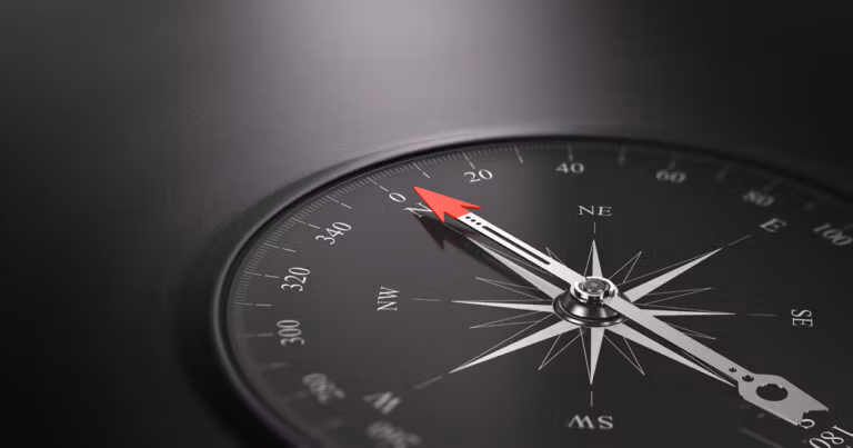 Black compass pointing north