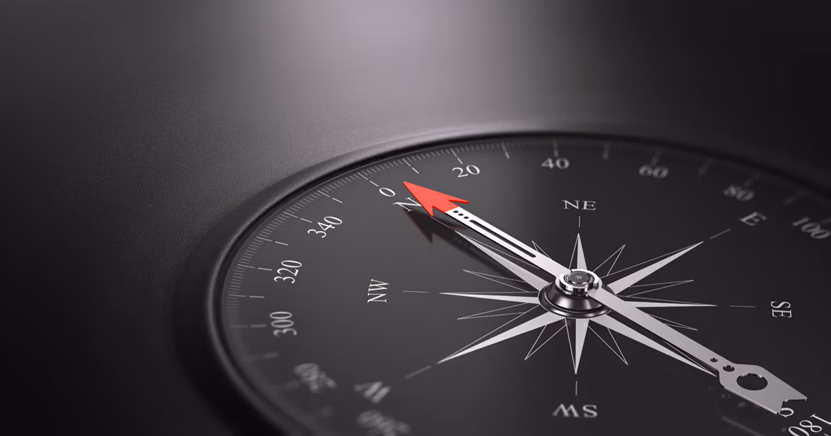 Black compass pointing north